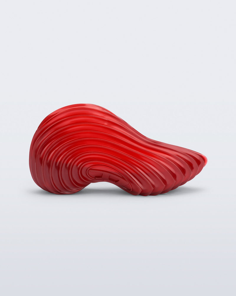 Side view of a transparent red Sneaker + Diesel