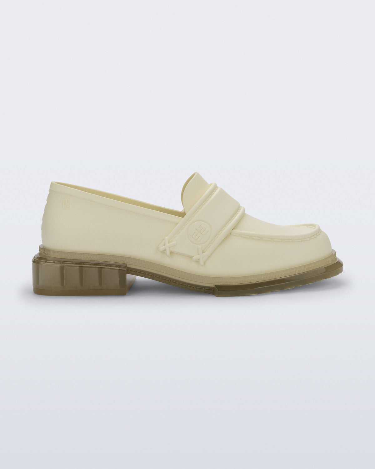 Side view of a beige Spencer loafer with clear beige sole