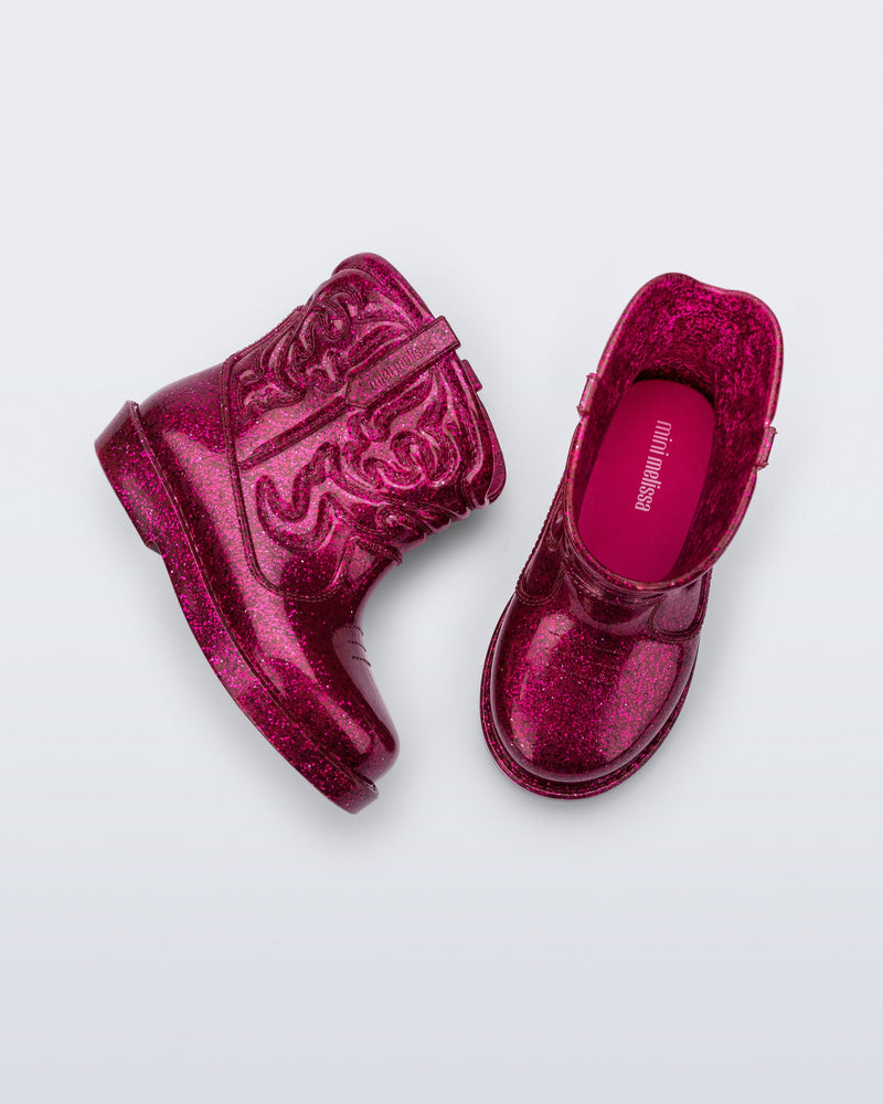 Top and side view of a pair of glitter pink Texas baby boots
