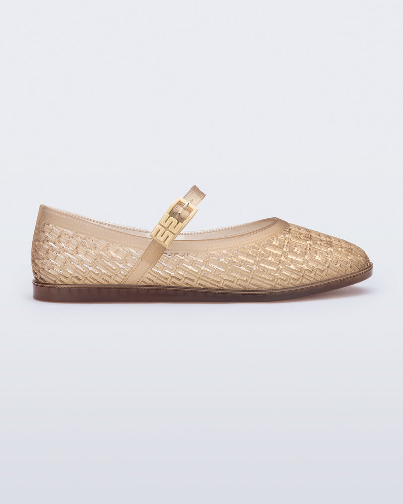 Side view of a clear beige Harper flat with strap