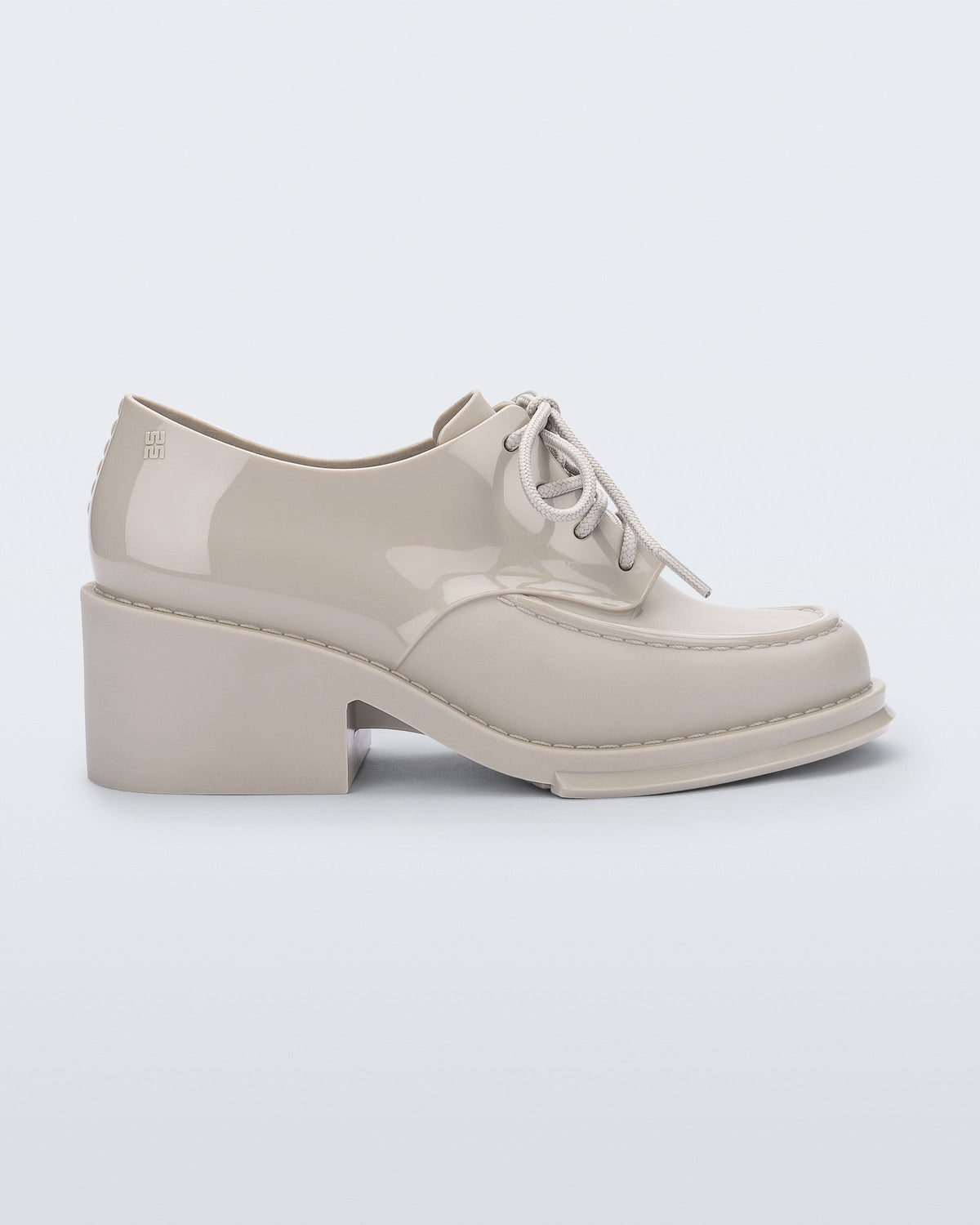 Side view of a beige Tailor loafer with laces