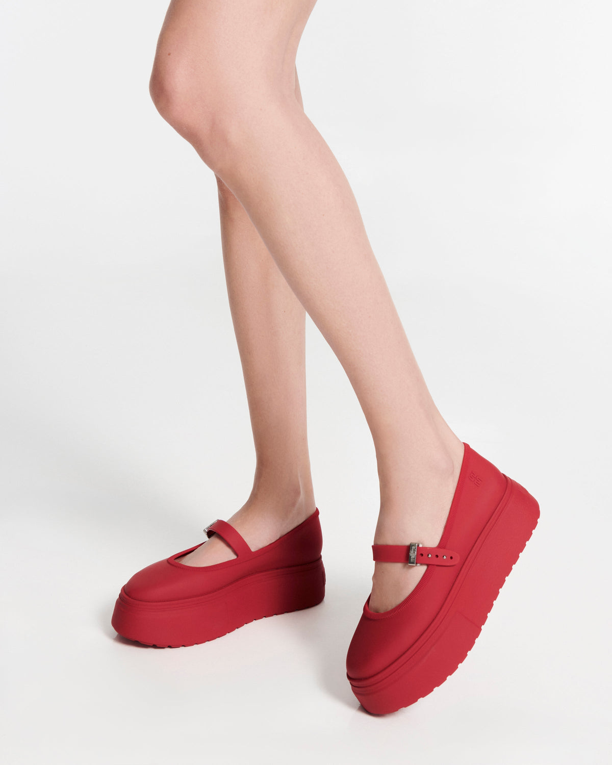 Model's lets in a pair of red Soft Ballerina Platform flats