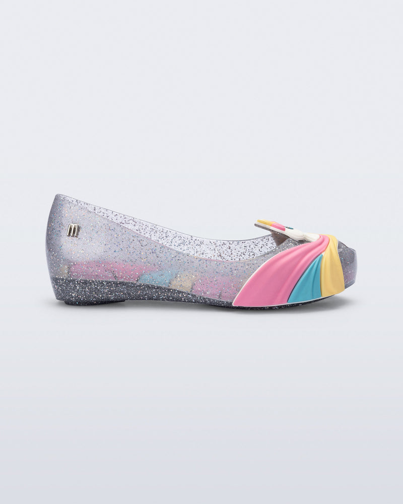 Side view of a glitter clear/pink kids Ultragirl Unicorn flat