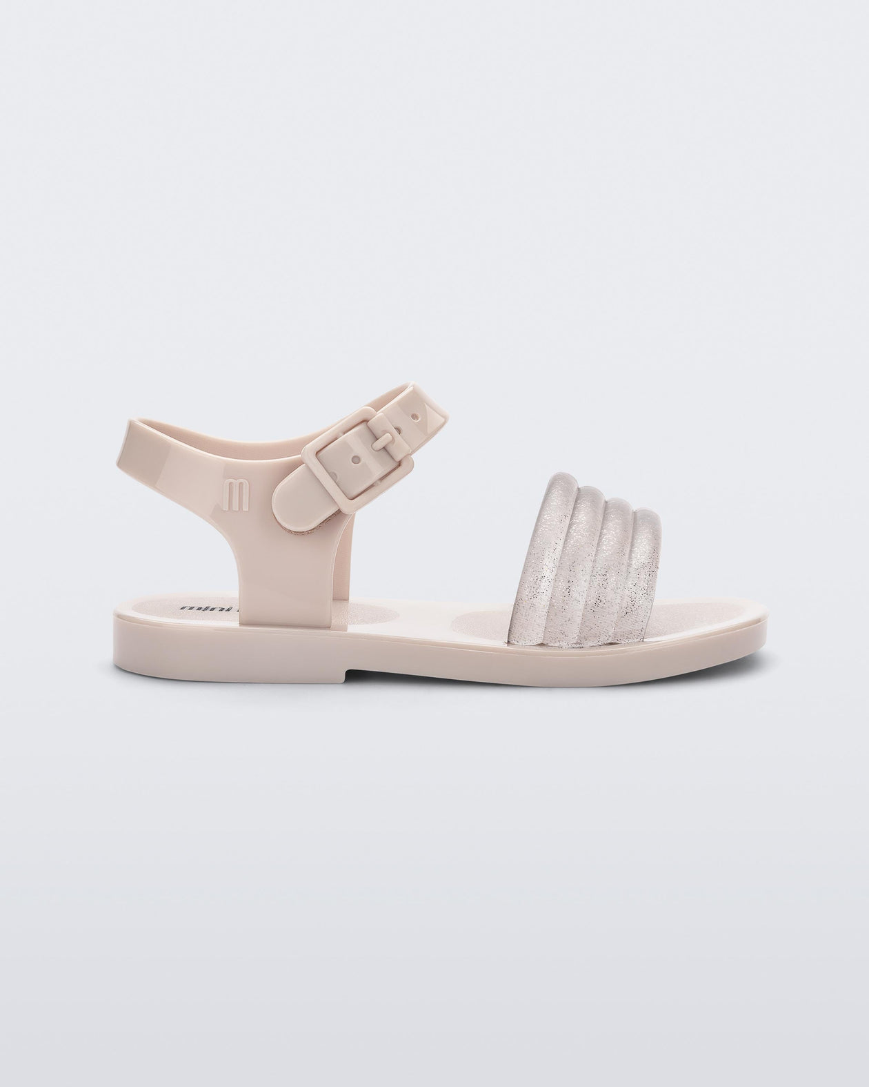 Side view of a beige Mar Wave baby sandal.