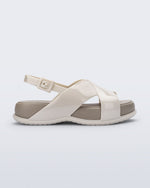Side view of the Melissa Mare platform sandal. This sandal has two cross straps across the front part of the foot with a thin buckle strap attached. The straps and outsole are light beige while the platform insole is a darker beige.