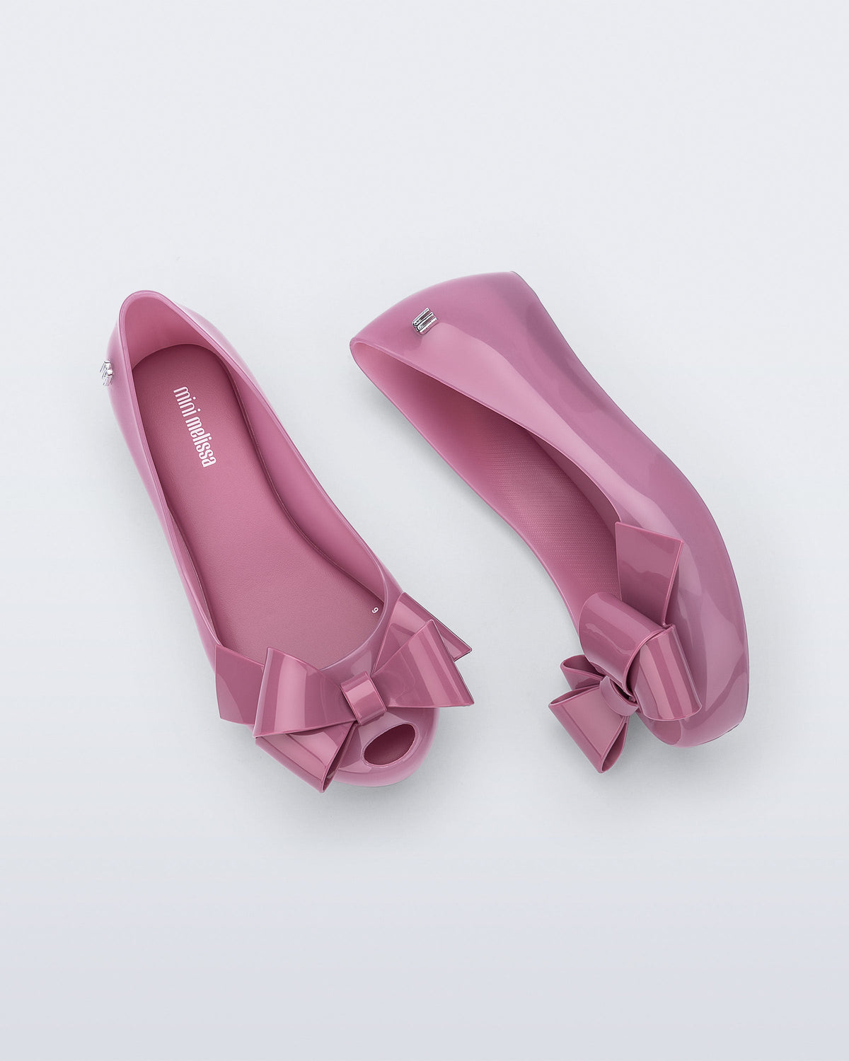 Top and side view of a pair of lilac Ultragirl Classy baby ballerina flats with lilac bow