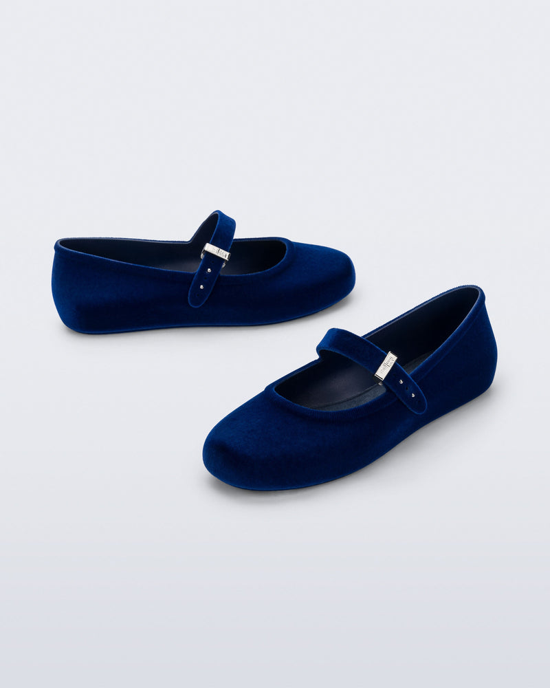 Side and angled view of a pair of blue Soft Ballerina Velvet II flats