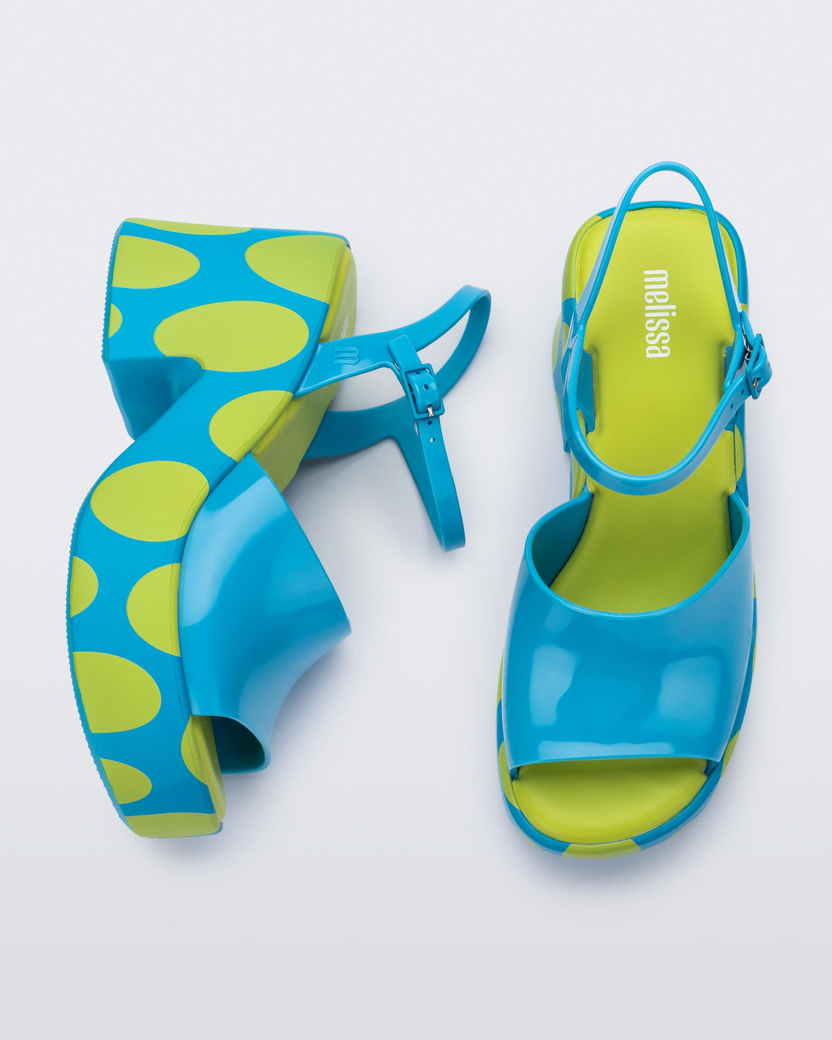 Top and side view of a pair of blue with green polka dot sole Lina platform heels