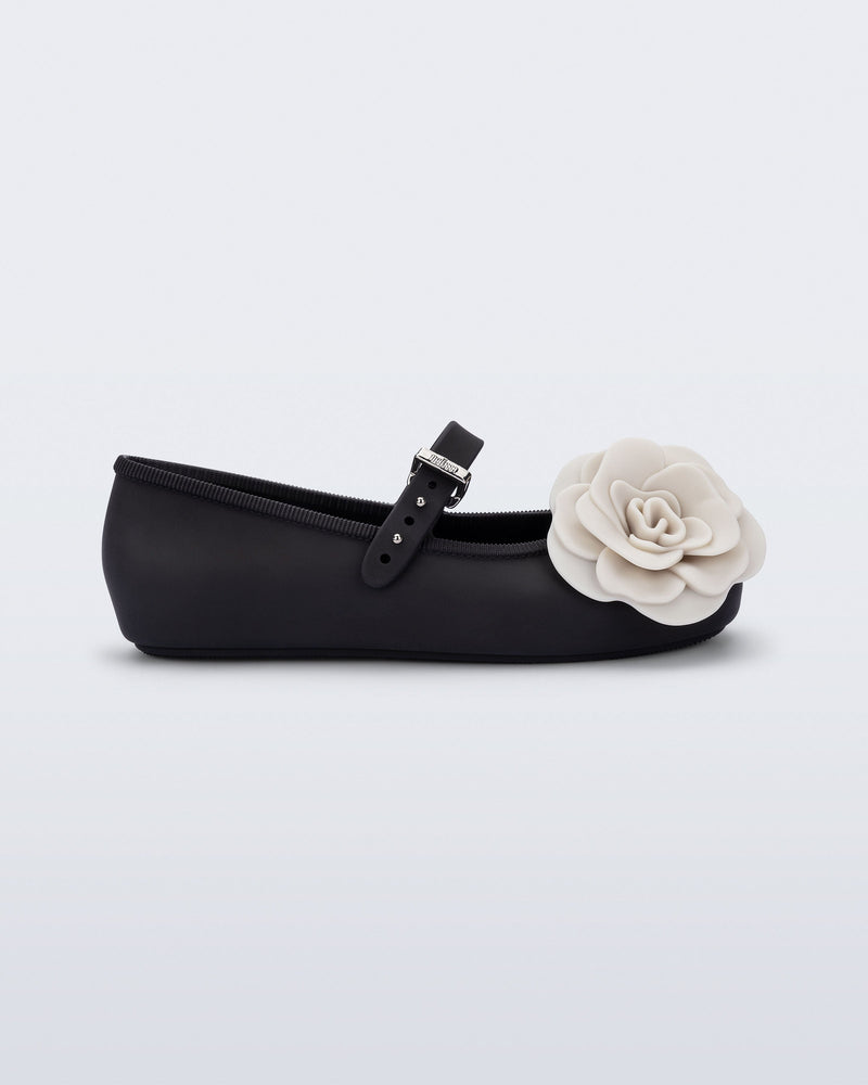 Side view of a black Soft Ballerina Petals kids flat with beige flowers