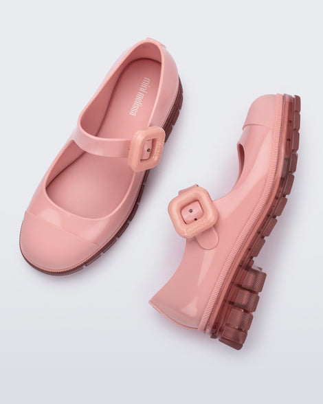 Top and side view of a pair of pink June mary janes with matte toe cap