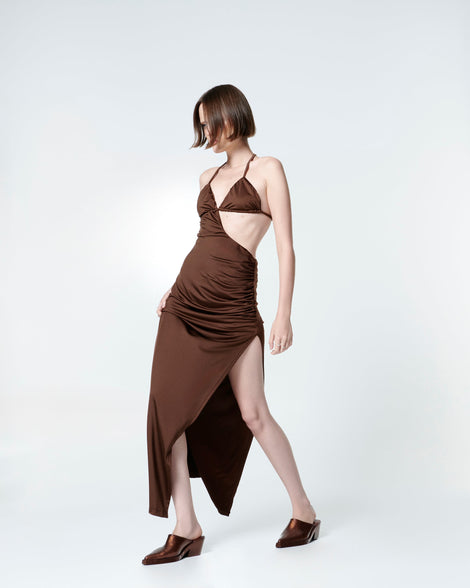 Model in a brown dress wearing a pair of bronze glitter Texas Mule heels