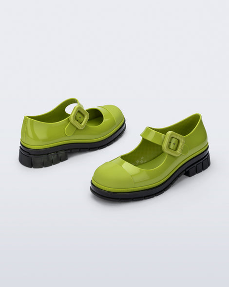 Back and side angle view of a pair of green with black sole June mary janes with matte toe cap