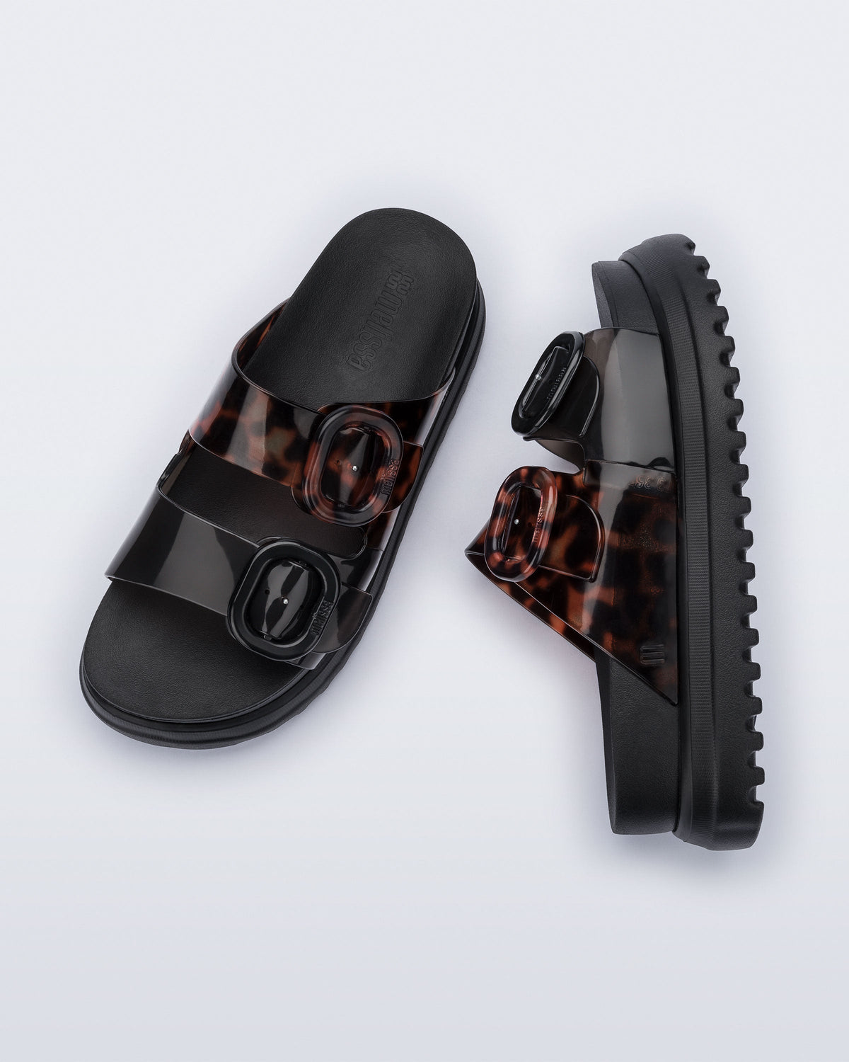 Top and side view of a pair of black Cozy Platform sandals with tortoise color straps
