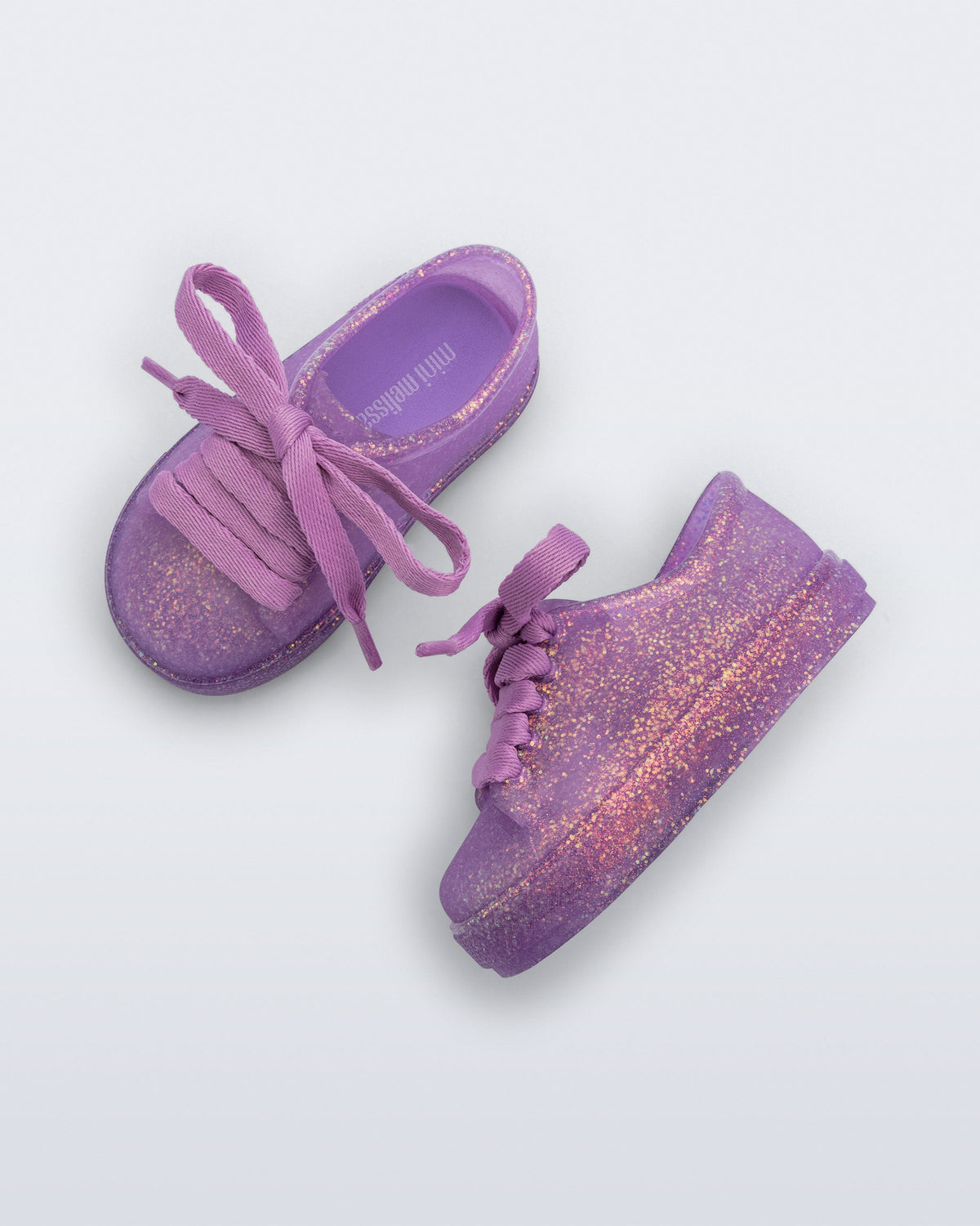 Side and top view of a pair of glitter lilac baby Hip Sneakers lilac laces