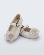 Angled view of a pair of beige Soft Ballerina baby flats with beige flowers