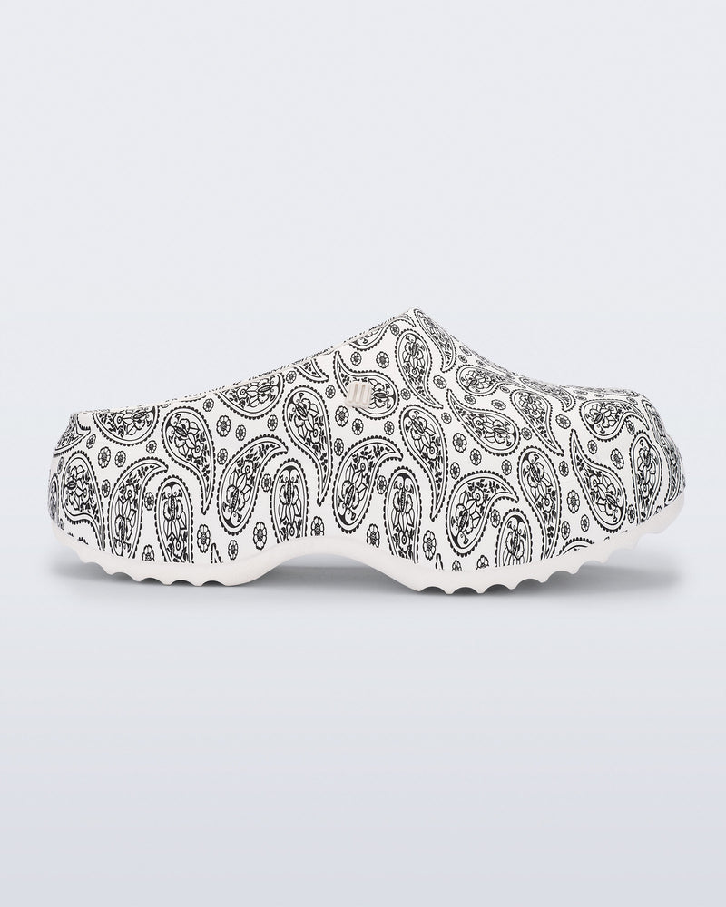 Side view of a white Free Clog Print Platform with black paisley print.
