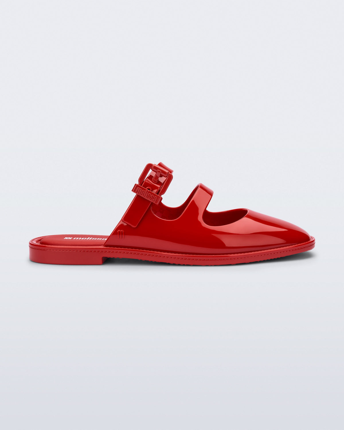 Side view of a red Anastasia mule slide with upper straps