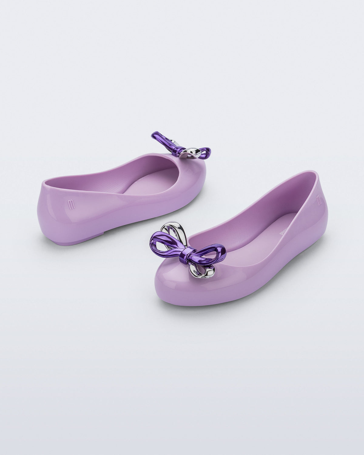 Angled and side view of a pair of purple Sweet Love Glam kids ballerina flats with bow