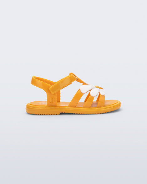 Side view of an orange Hip Bloom baby sandal