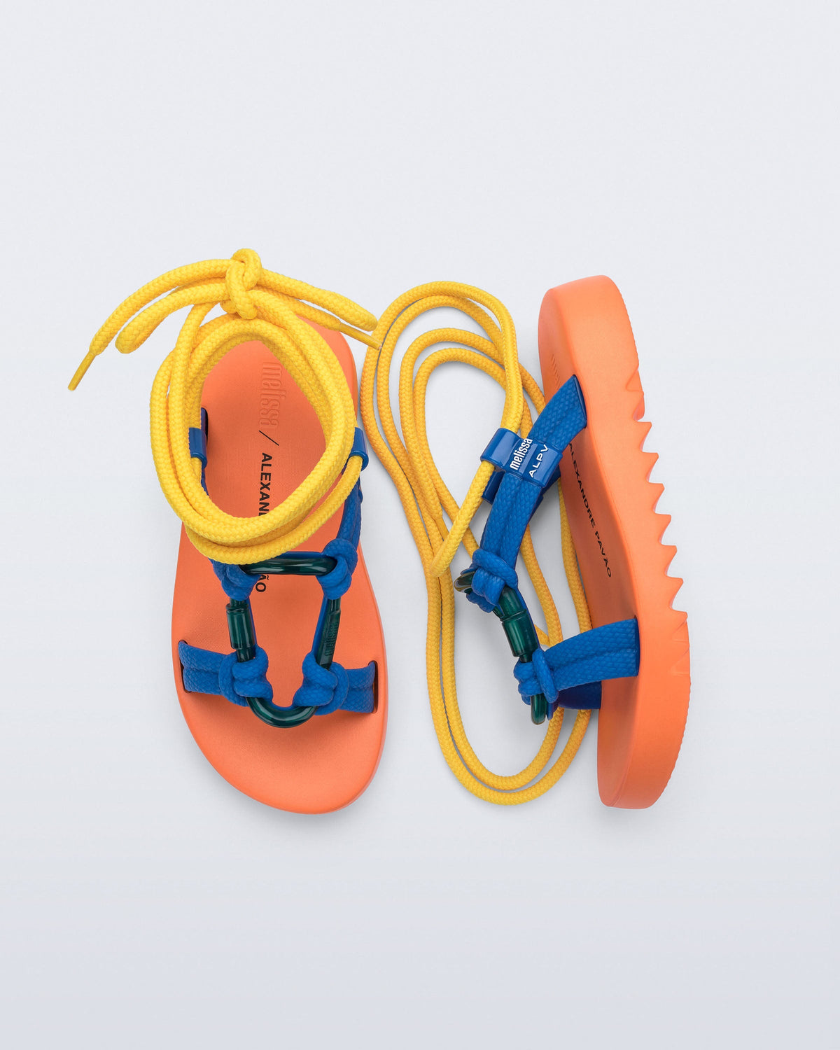 Side and top view of a pair of orange sole, blue upper, and yellow ankle strap Kirk + Alexandre Pavao sandals