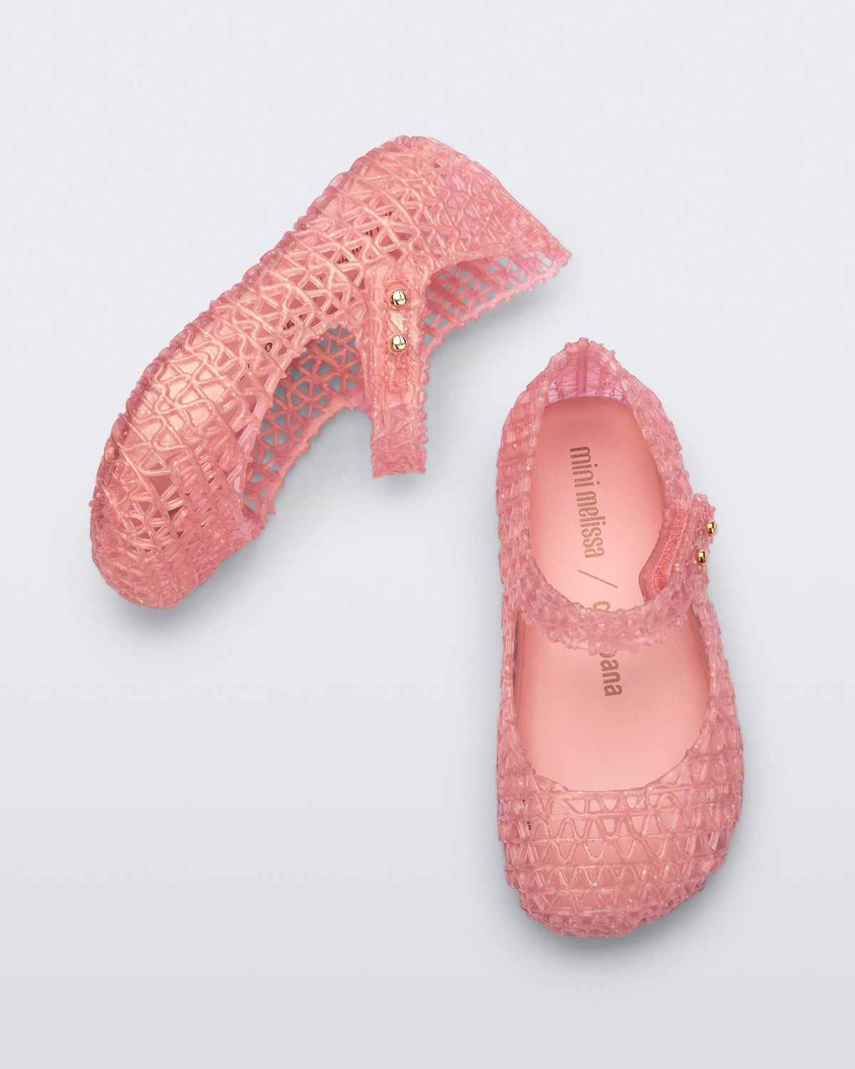 Top and side view of a pair of pearly pink baby Campana flats