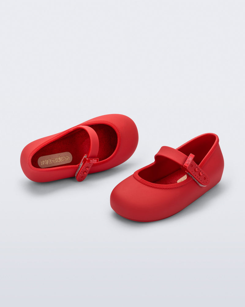 Top and side angled view of a pair of red Soft Ballerina baby flat with Velcro strap