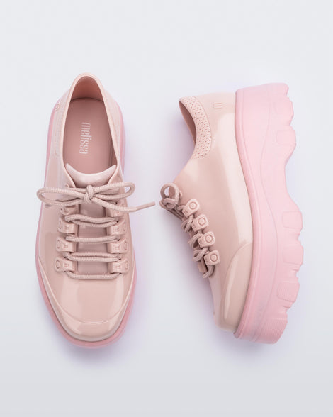 A top and side view of a pair of pink platform Melissa Kick Off Sneakers with laces.