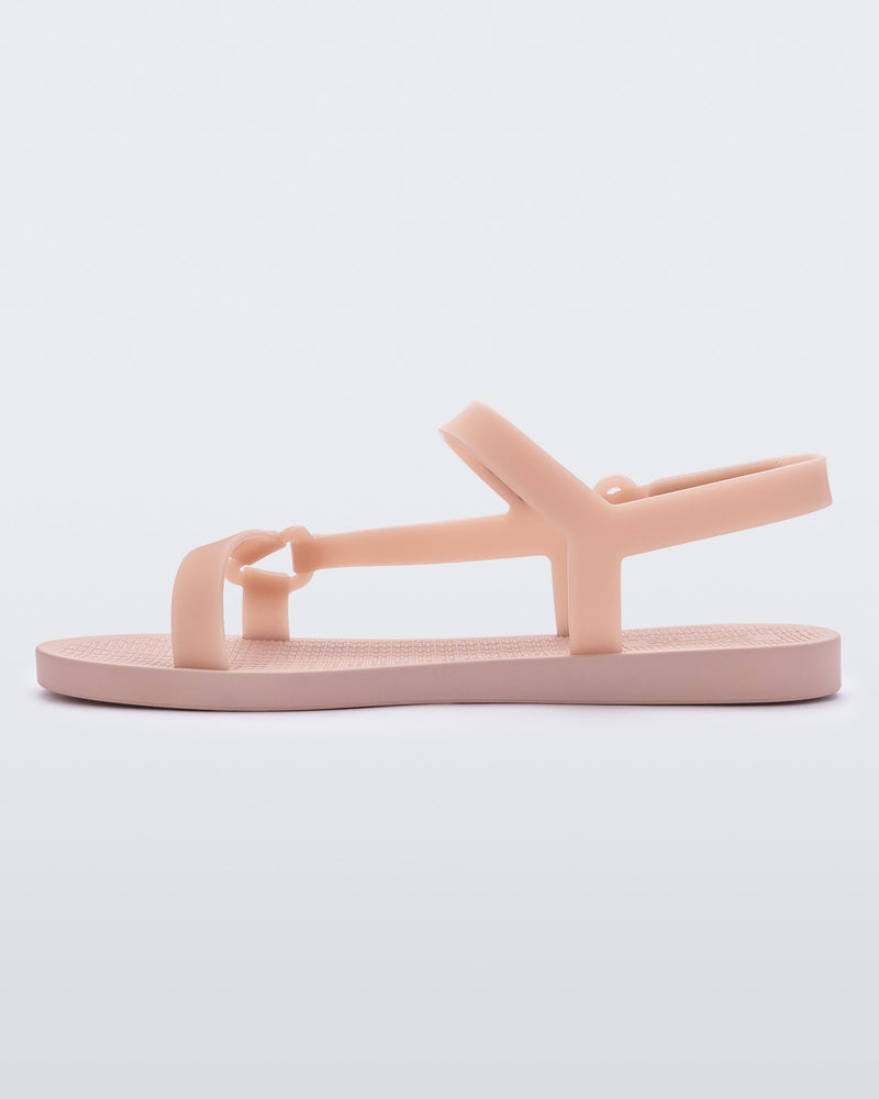 Inner side view of a Melissa Sun Downtown sandal with pink front cross and back ankle straps and a pink sole.