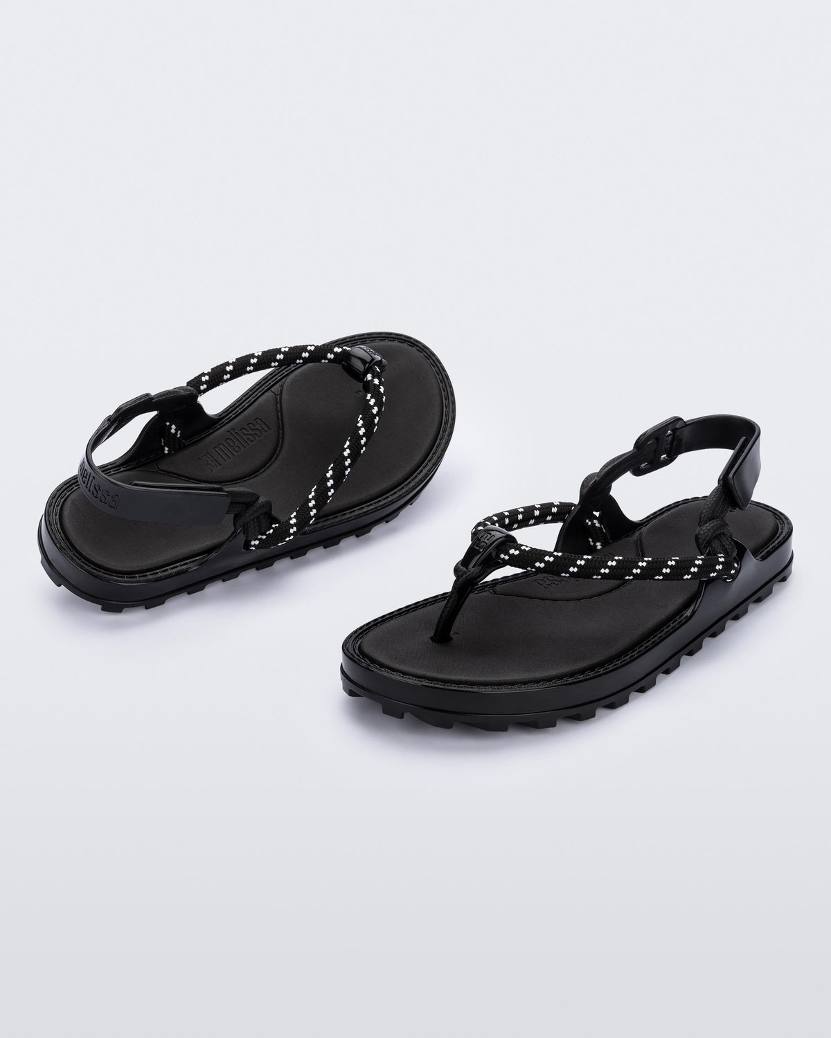 Angled view of a pair of black Bond sandals with textile strap and black toe piece