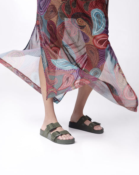 Model's legs wearing a pair of green Cozy M Love adult slides
