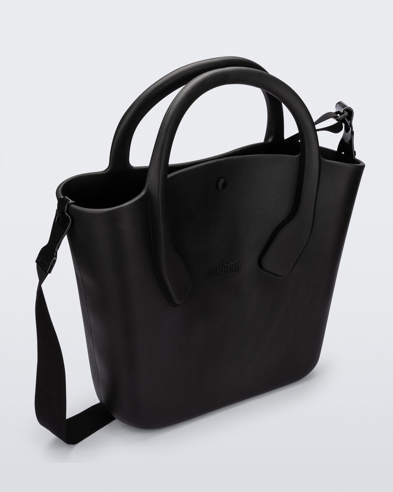 Angled view of a black Free Big Bag with handles and a strap
