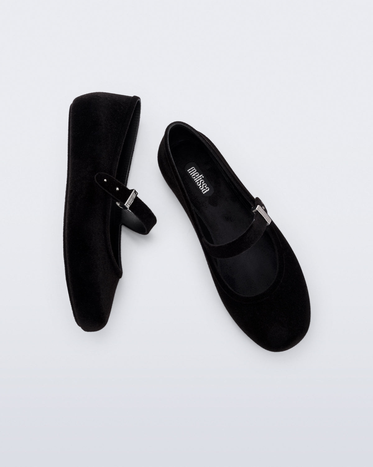 Side and top view of a pair of black Soft Ballerina Velvet II flats
