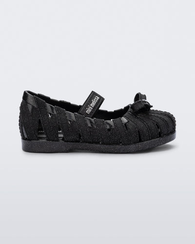 Side view of a glitter black M Lover Ballerina baby flat with bow and strap