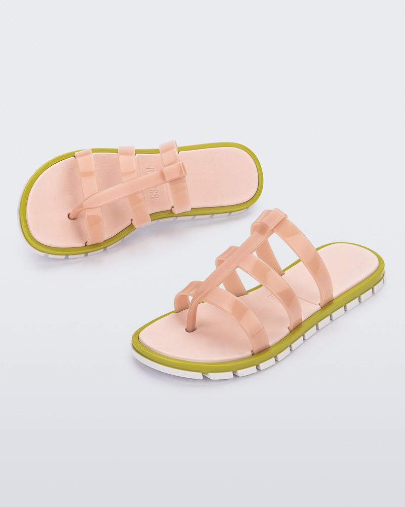 Top and angled view of a pair of pink Path adult sandals with  green sole