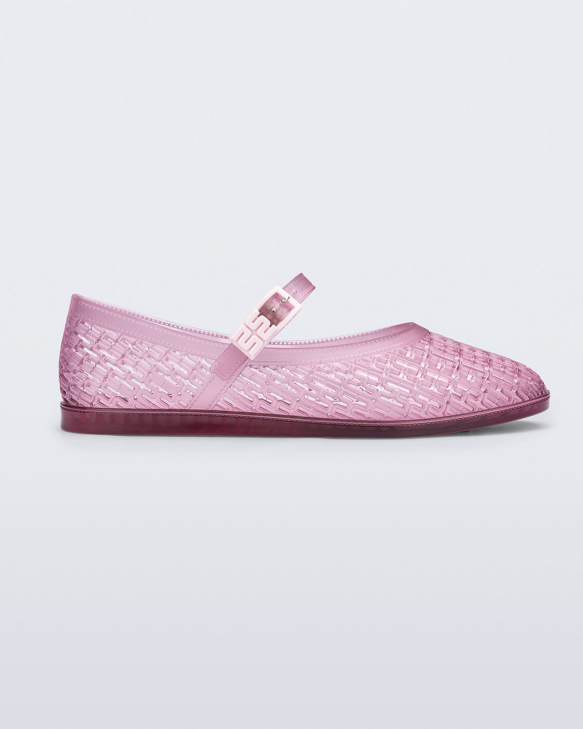 Side view of a clear pink Harper flat with strap