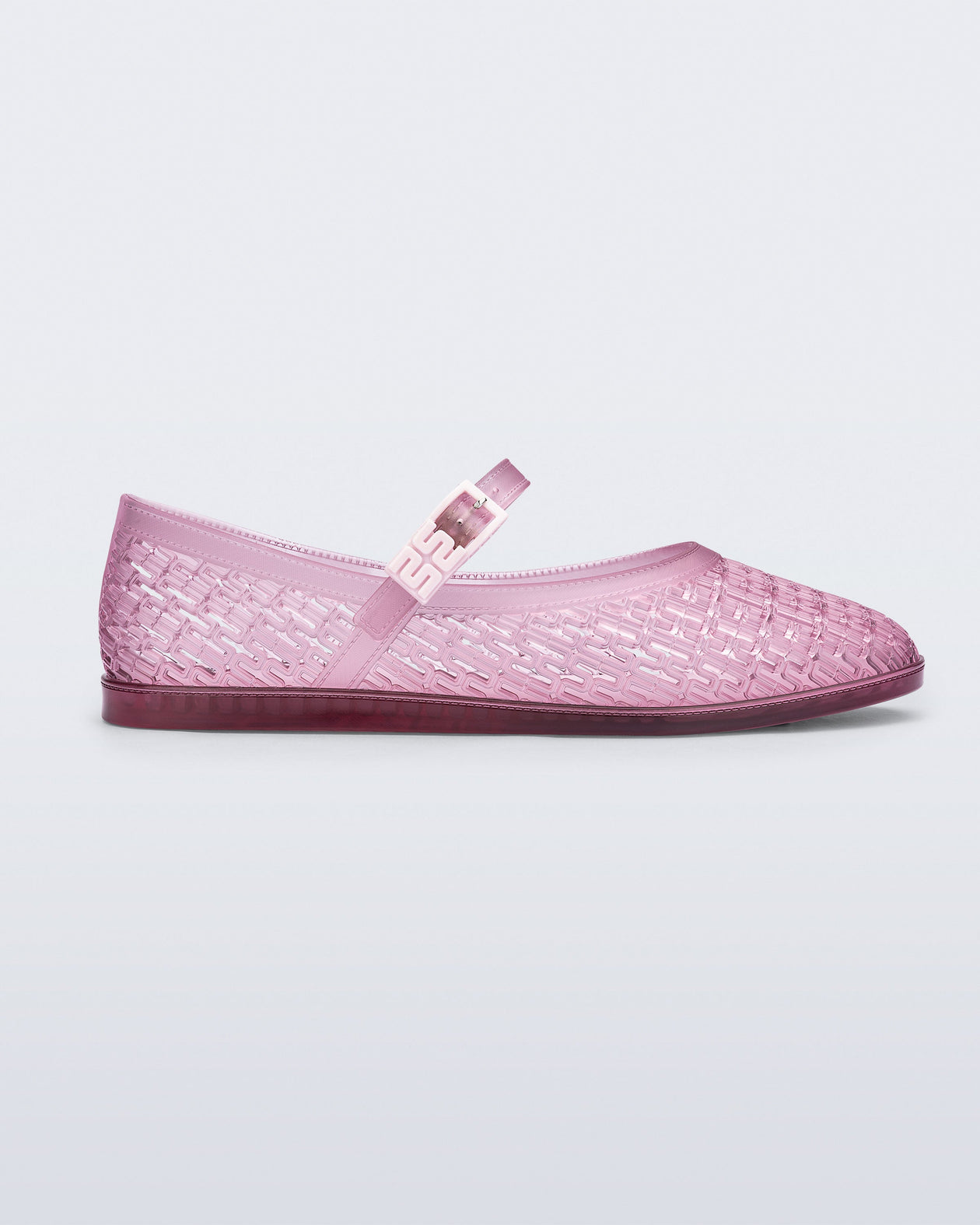 Side view of a clear pink Harper flat with strap