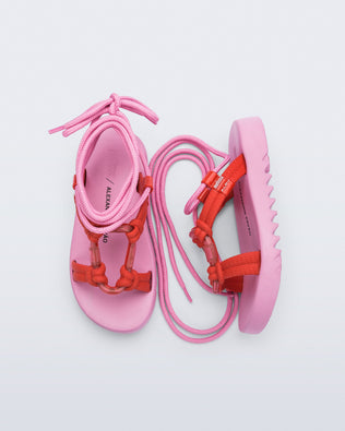 Side and top view of a pair of  pink sole, red upper, and pink ankle strap Kirk + Alexandre Pavao sandals