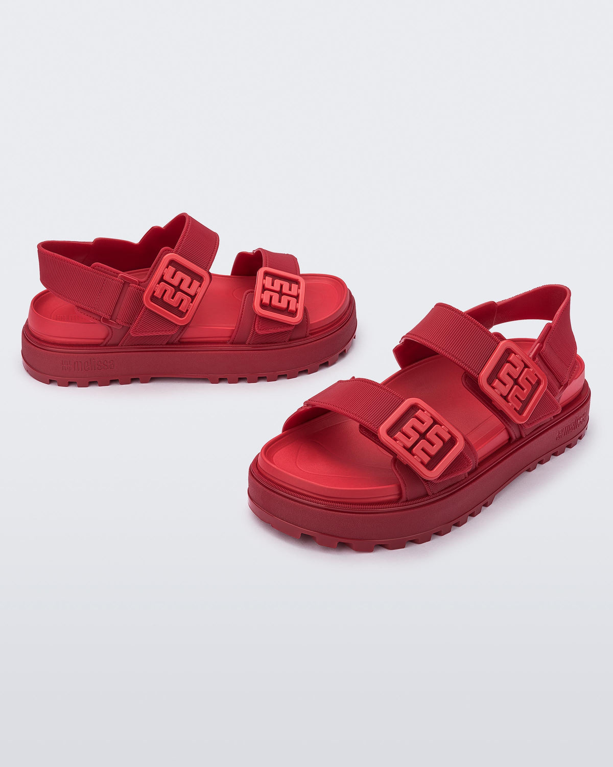 Side and front angled view of a pair of red Towny sandals with straps