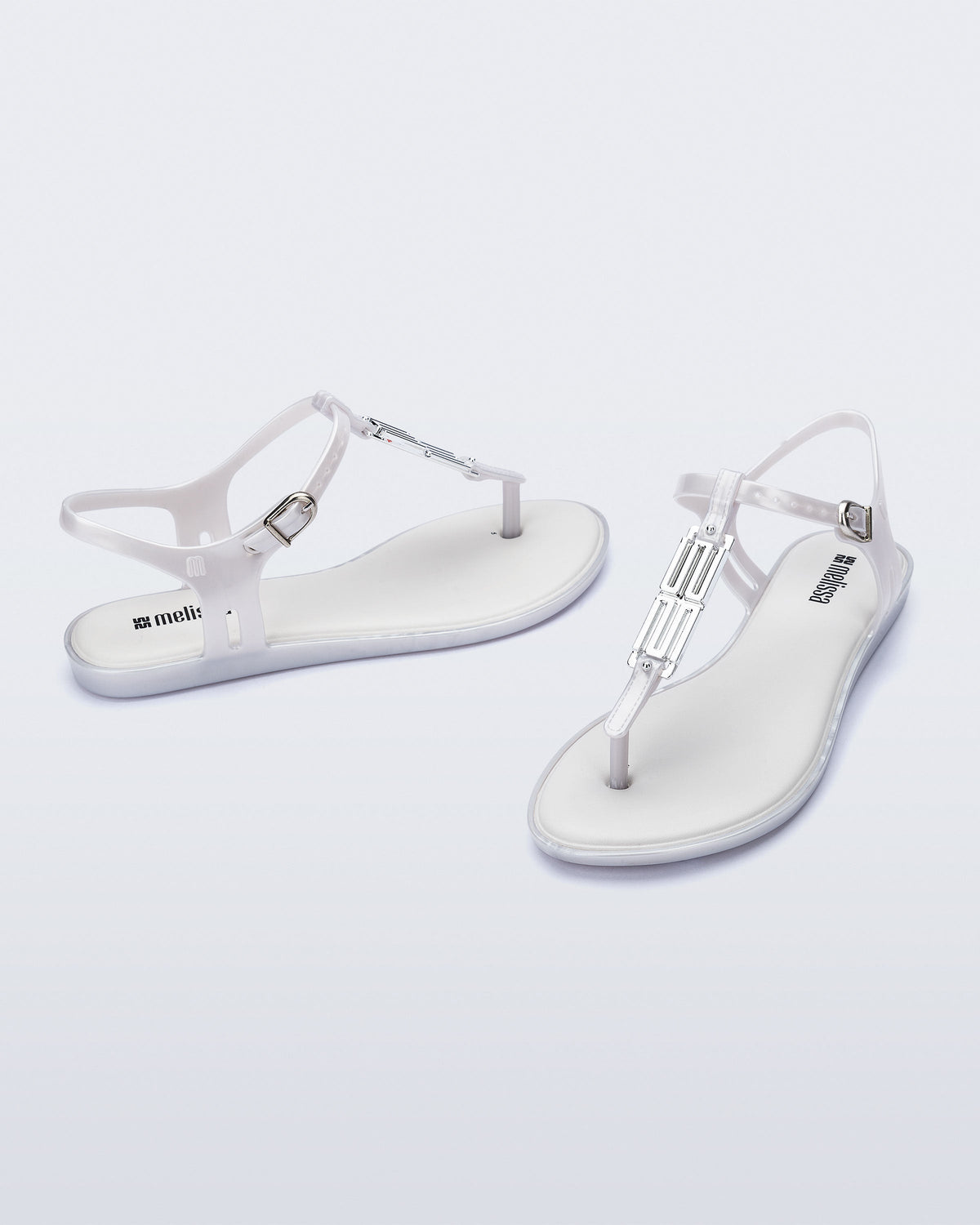 Side and front view of a pair of pearly white Solar M Chic sandals