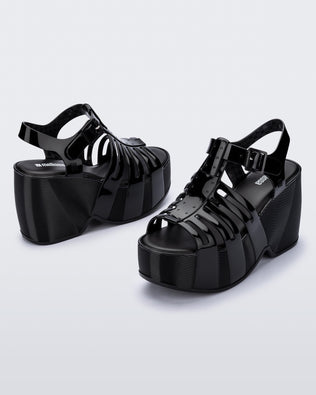 Back and side angled view of a pair of black Station 79 platform heels with ankle straps