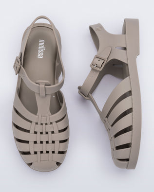 Top and side view of a pair of matte beige Possession adult fisherman style sandal