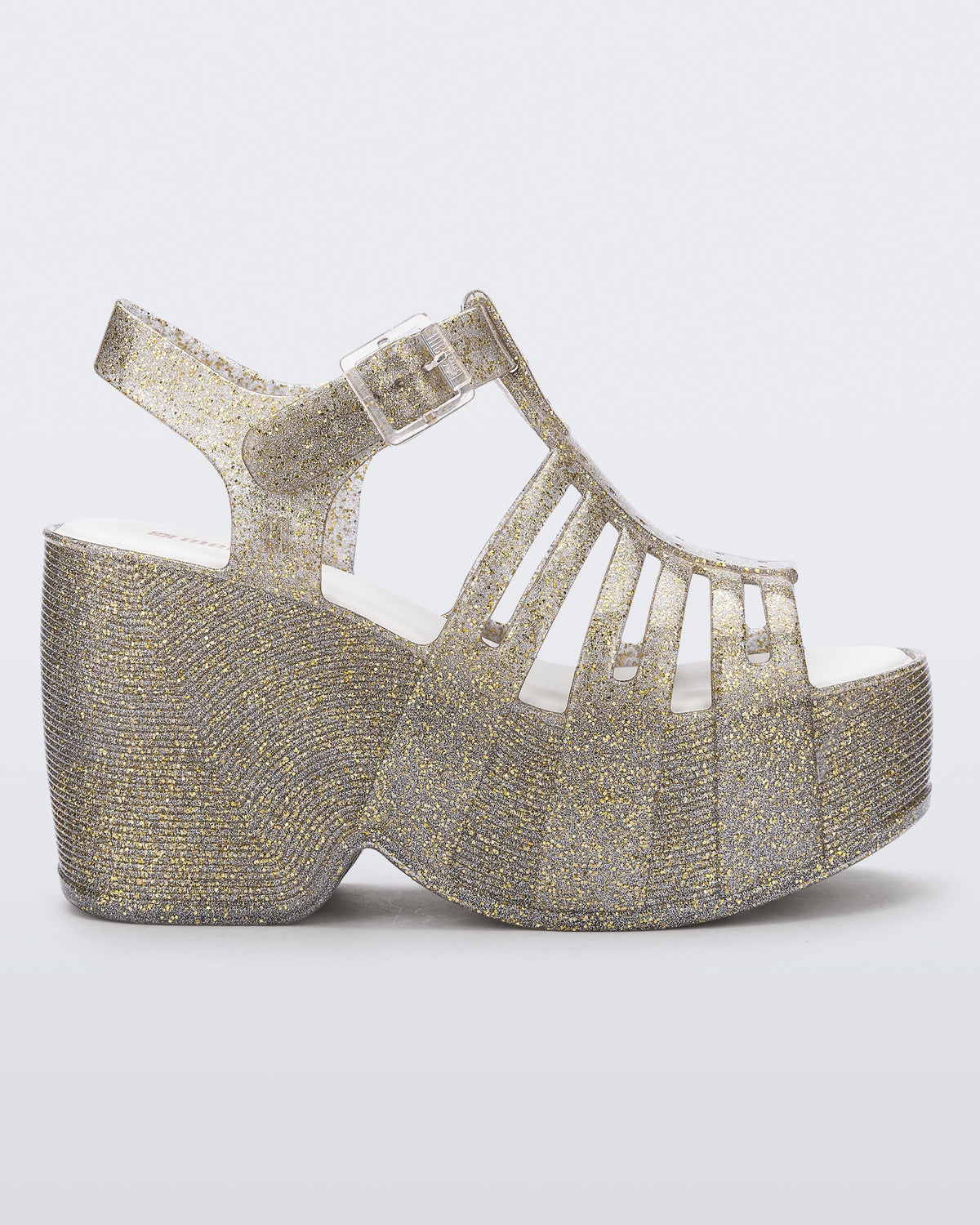 Side view of a glitter gold Station 79 platform heel with ankle strap