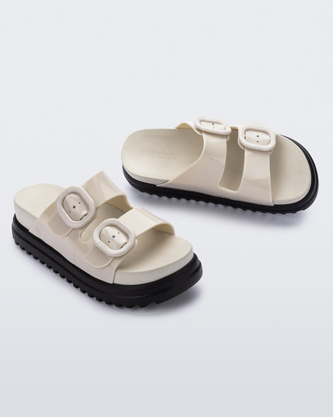 Angled view of a pair of beige Cozy Platform slides.