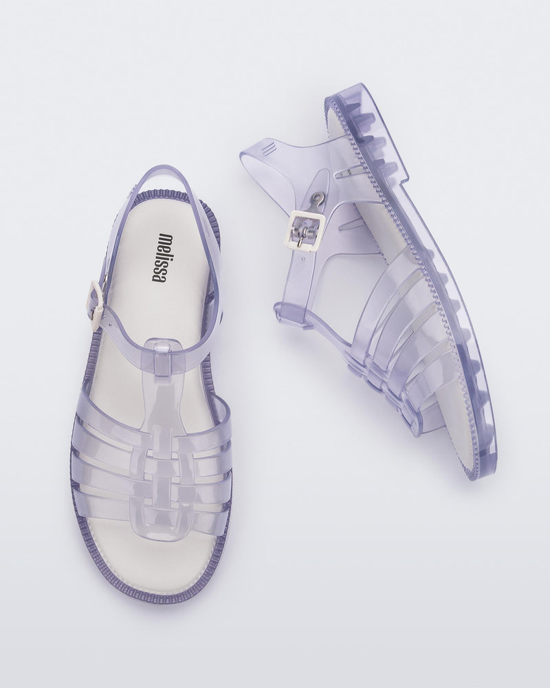 Top and side view of a pair of clear Possession Fresh fisherman style sandals with open toe.