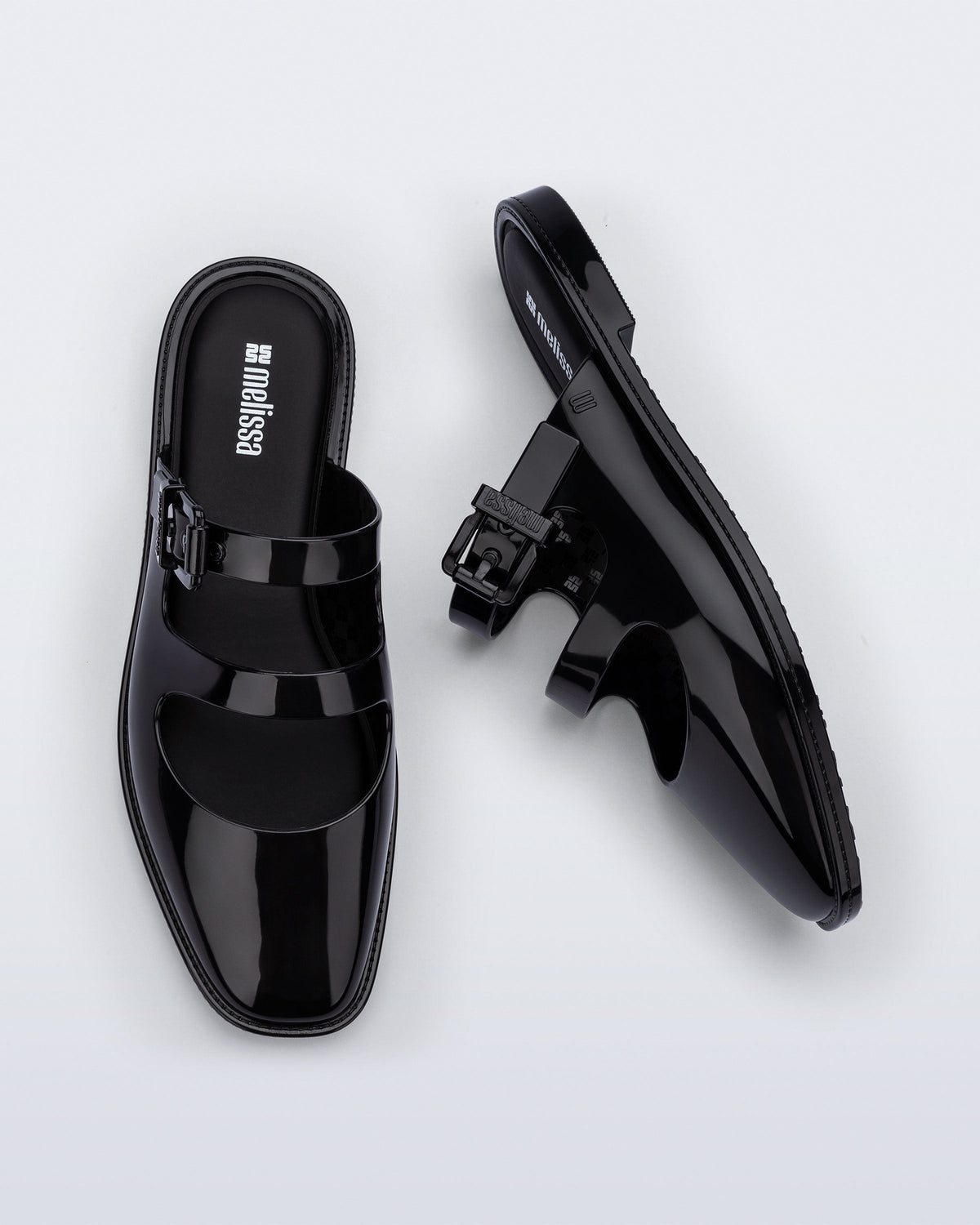Side and top view of a pair of black Anastasia mule slides