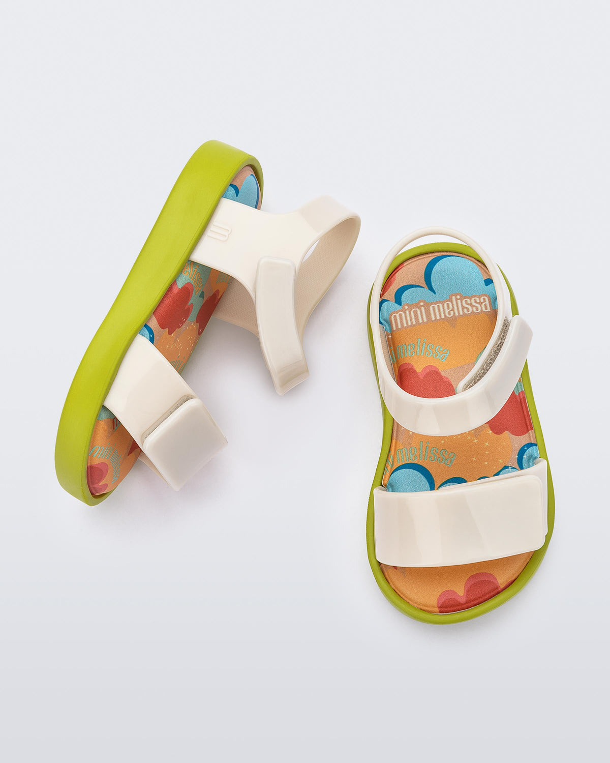 Top and side view of a pair of beige baby Jump sandals with green sole