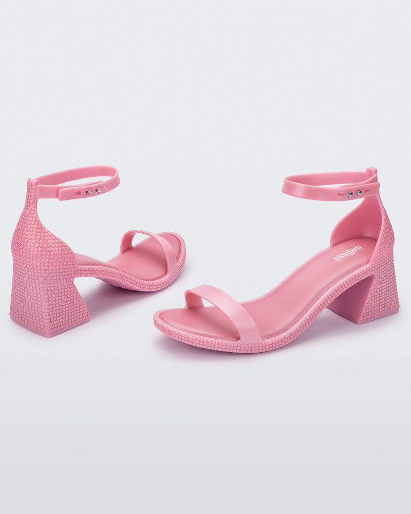 Angled view of a pair of metallic pink Lux Heels