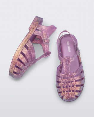Top and side view of a pair of glitter lilac kids Possession sandals