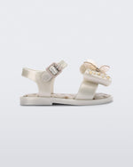 Side view of the Mini Melissa Mar Sandal with star print for baby in white with butterfly bow applique and velcro closure on ankle strap.