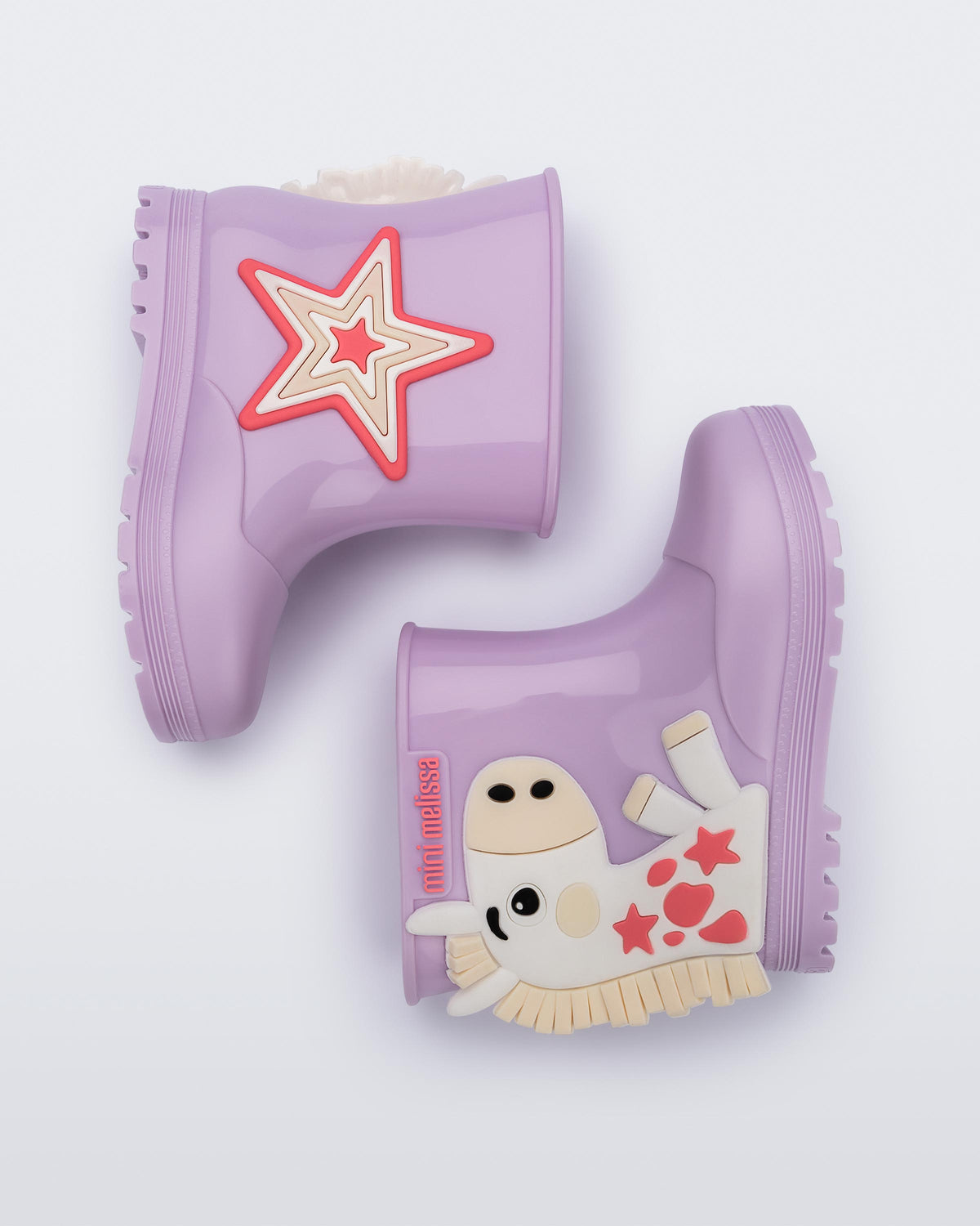 Side view of a pair of white Welly Wonderland baby boots with orange pony on one shoe and star on the other